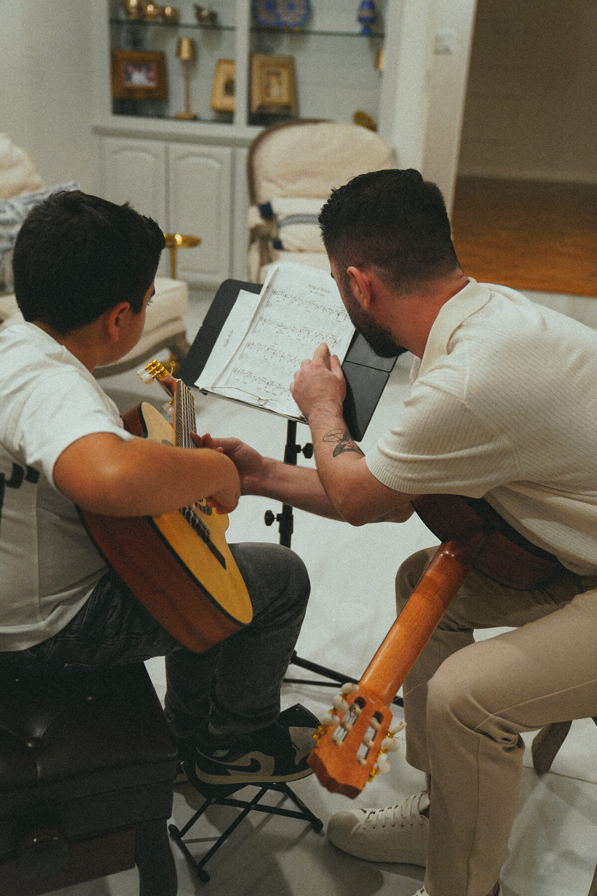 Student reading sheet music with instructor